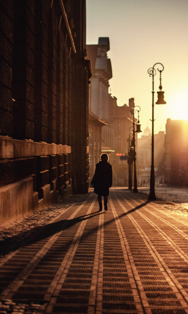 boy-walking-street-sunset